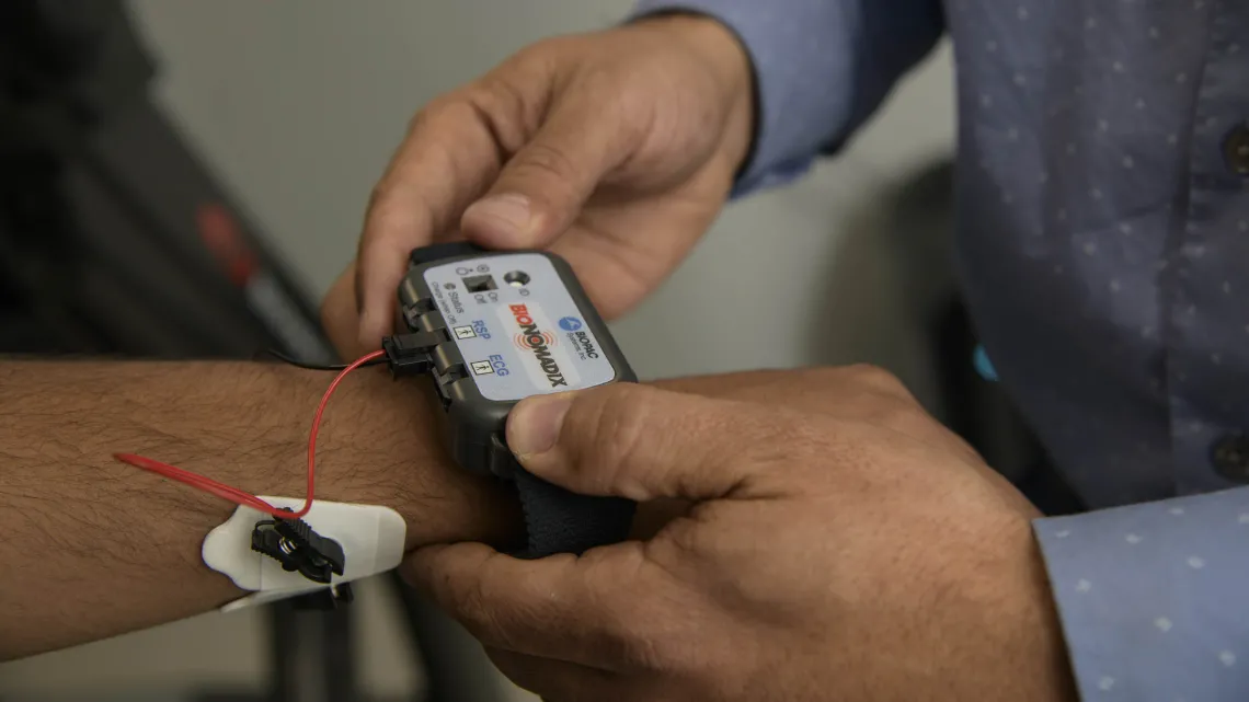 Person reads information from a sensor worn on the forearm