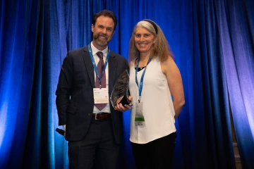 Photo of Dr. Jason Lowe receiving his award
