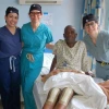 Dr. Kim Tucker standing with three colleagues and a knee surgery patient