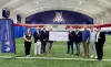 Photo of Banner Sports Medicine and Orthopedics employees and the Tucson Conquistadores holding a donation check